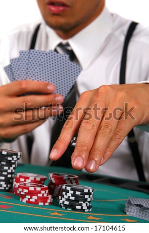 Playing Cards Young man playing poker. He is holding cards and chips in his hands. Isolated over white background.