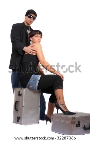 Young stylish couple isolated over white. She is sitting on dj cases.