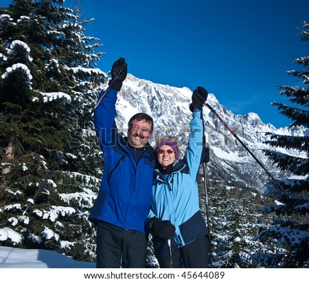 A senior couple in a winter setting in the alpine mountains. Active and happy seniors.