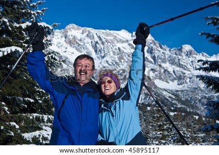 A senior couple in a winter setting in the alpine mountains. Active and happy seniors.