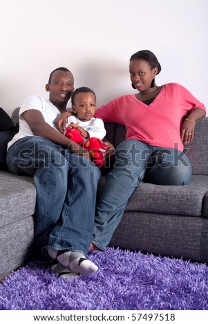 Young afro american family in a living room setting.
