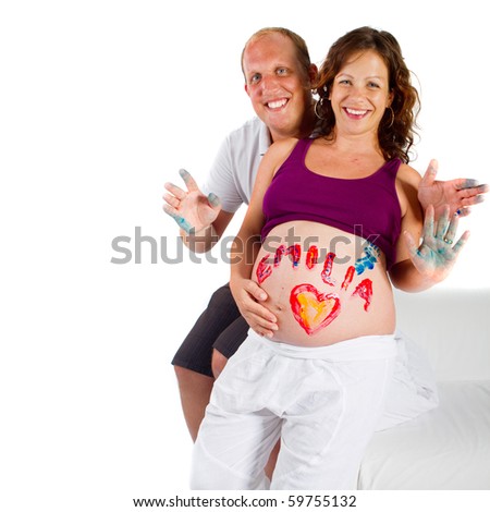 Young pregnant woman with the painted name of her baby girl written on her belly.