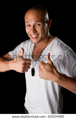 stock photo Young male filipino model over a black background is gesturing