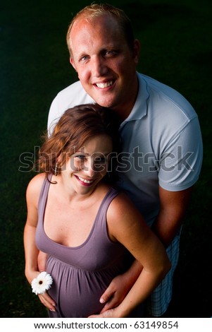 Young fresh happy couple with a pregnant woman. Shot from above - new fresh angle.