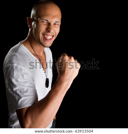 stock photo Young male filipino model over a black background is gesturing 