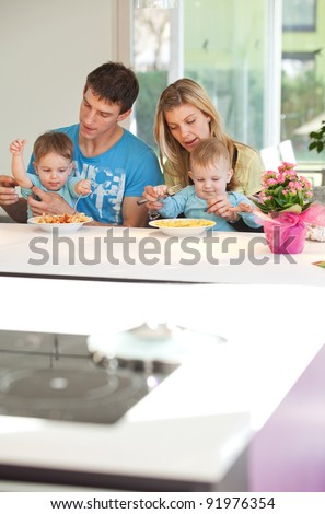 Young family having a hard time feeding baby twins
