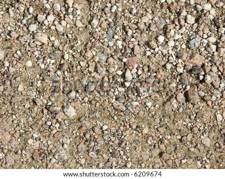 Heap of fine stones. In regular intervals (mixed up with sand)
