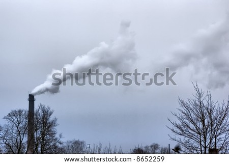 Pipe of heating. A light smoke in the dark sky. Cloudy.