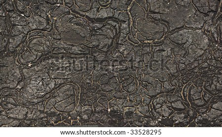 Old tar (tarmac) covering. It is a lot of cracks. It is visible small sand