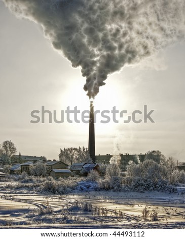 Smoke of thermal station. Frosty (cold) day. It is photographed against the sun. It is processed in graphic programs.