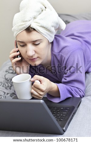 Lady with towel wrapped hair in front of laptop