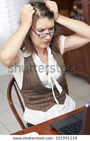 Frustrated young lady pulling her hair out