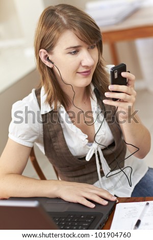 Young lady listening to music on cellphone