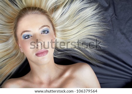 Beautiful Caucasian teenage model with long blond hair combed straight