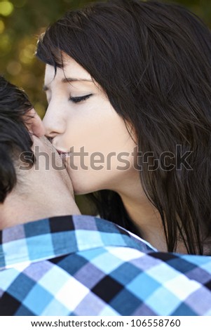 Girlfriend kissing her boyfriend on the cheek