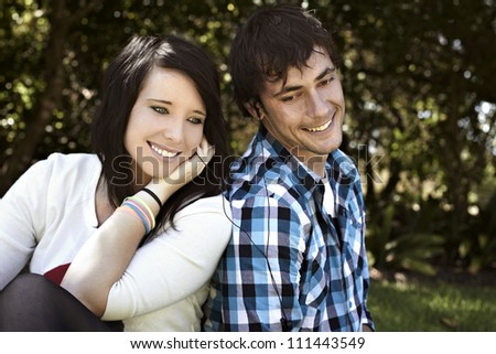 Romantic young couple sharing audio device while listening to music