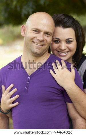 Young lady holding man from behind