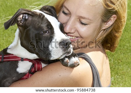 Happy dog owner with her Pit Bull puppy