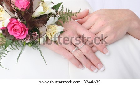 Pair of hands, showing off rings with flowers on wrist, symbolize love and togetherness