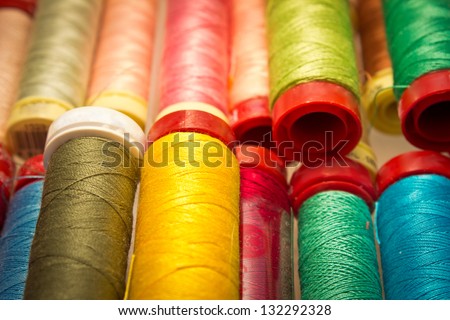 new and used colorful cotton threads close-up
