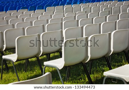 white and blue chairs before a concert in a park
