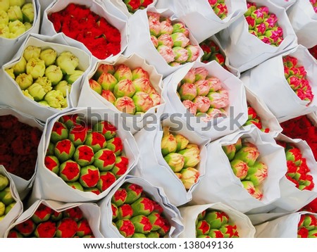 Bouquets of pink and red flowers, wrapped in paper and put in order on a stall in Hong Kong Flower\'s market