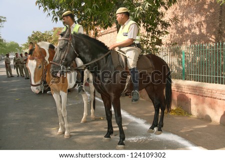AGRA, INDIA - MARCH 31:Mounted Police on horseback patrolling the streets in Agra near the walls of the Taj Mahal on march 31, 2012 in Agra, Uttar Pradesh, India.