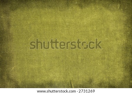 An old shabby green textile canvas with dark borders
