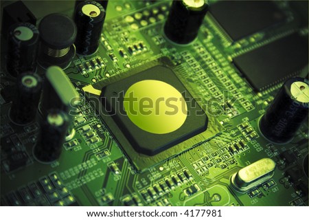 Futuristic high technology chip, surrounded by capacitors, microcircuitry & quartz. Image in beauty green colors, processor pointed by light spot