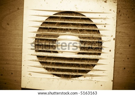 An old dirty grunge element: fan with plastic grate