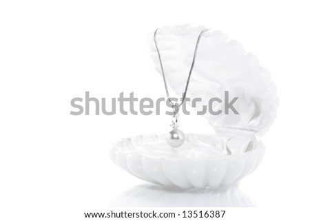 High-key image. White shell with pearl necklace inside over white background