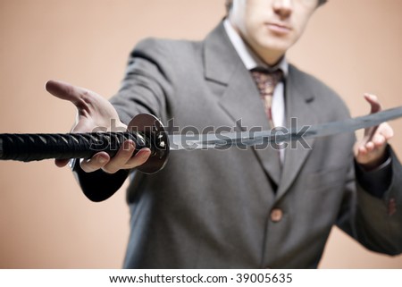 Businessman giving a sword ( symbol of struggle). Partner in business concept, new leader concept