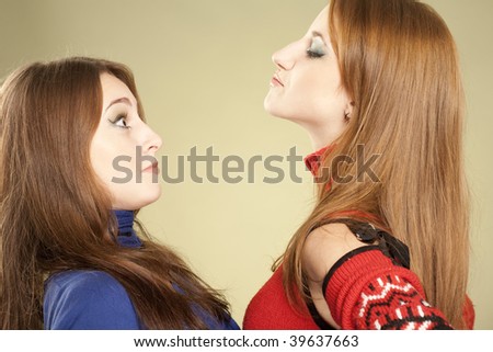 Fun humorous picture: one girl showing her domination and scaring another one girl.