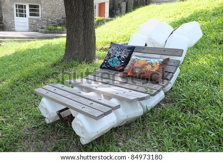 plastic barrel and wooden bed outdoors