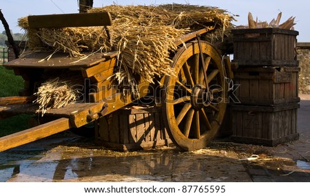 Wooden wagon loaded with a number sheaves of wheat