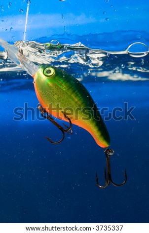 fishing bait underwater in a blue clear water
