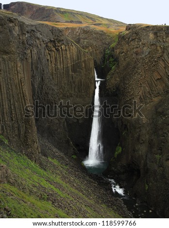 Tall Waterfall with basalt columns in Iceland