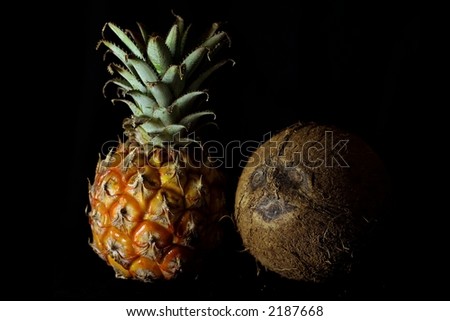 pineapple and coconut upon black background