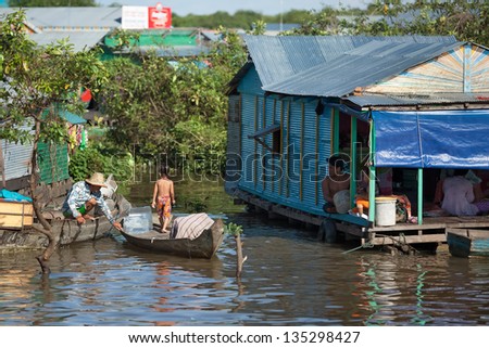 SIEM REAP, CAMBODIA - SEPT 25 : Cambodian people live beside Tonle Sap Lake in Siem Reap, Cambodia on September 25, 2012. This is the largest freshwater lake in SE Asia peaking. Annual flooding of the village.