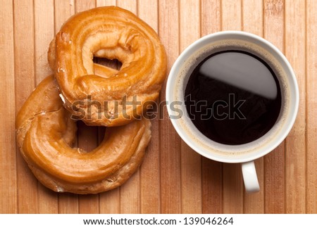 sweet breakfast: cup of coffee and sweet rings with cottage cheese
