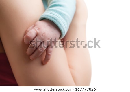 mother holds the child. the baby holds a mother\'s hand. isolated on white