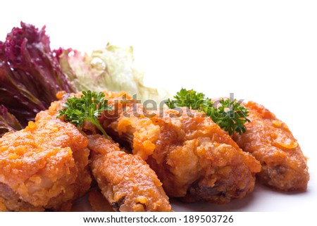 fried bird in sour sweet sauce with parsley leaves. on a white background