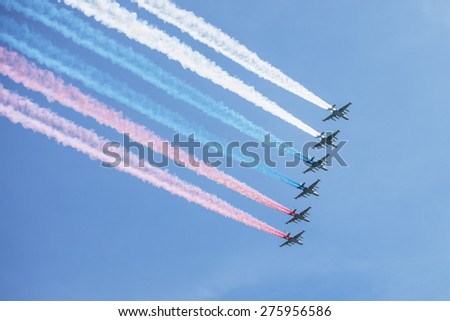 MOSCOW, RUSSIA - MAY 7, 2015: A group of aircraft in-flight smoke color Russian flag. Rehearsal of parade devoted to May 9, 70-th Victory Day in World War II. May 7, 2015 in Moscow.