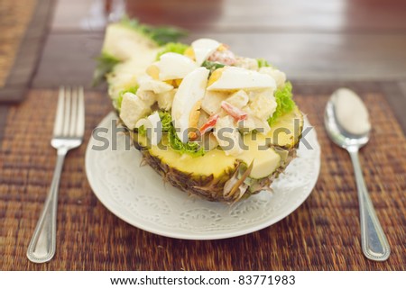 On a table salad Hawaii in pineapple