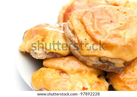 Fried meat stake with onions, tomatoes and cheese on French on a white background