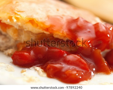 Fried meat stake with onions, tomatoes and cheese on French on a white background