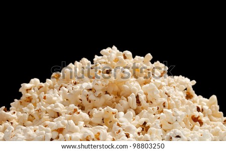 heap of popcorn isolated on black background.