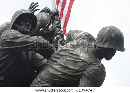 The United States Marine Corps War Memorial in a close-up of the Marines raising the American Flag.  Stark, with the flag lending color to the scene.