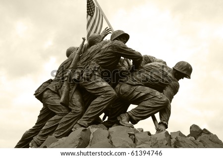 The United States Marine Corps War Memorial depicting the flag raising at Iwo Jima.  Black and white/sepia.