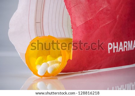 prescription bottle of pills inside a paper bag